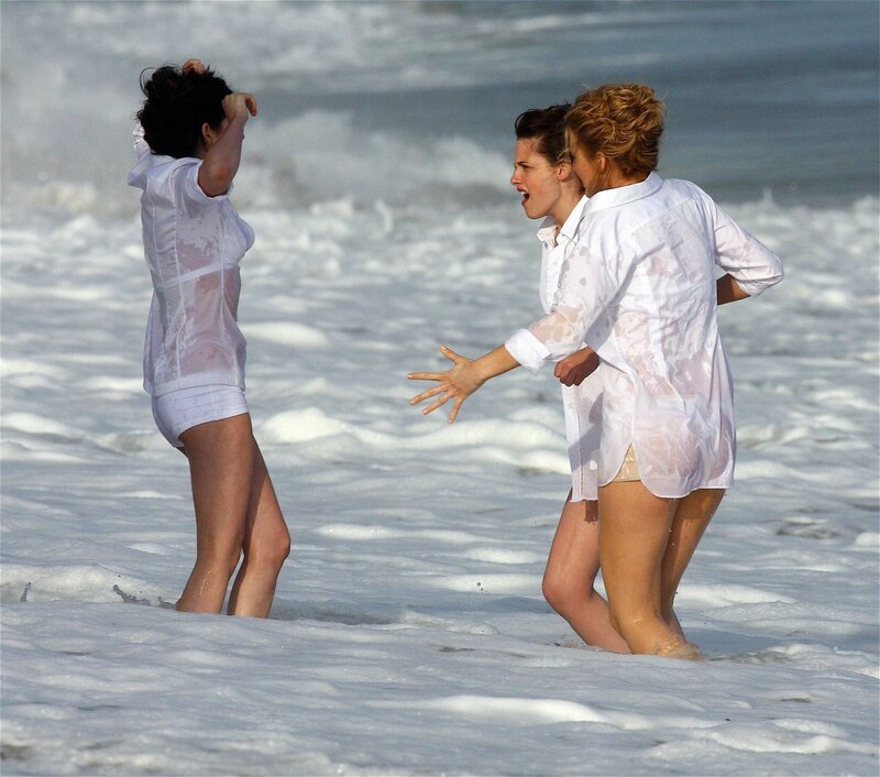 Women in wet shirts on beach