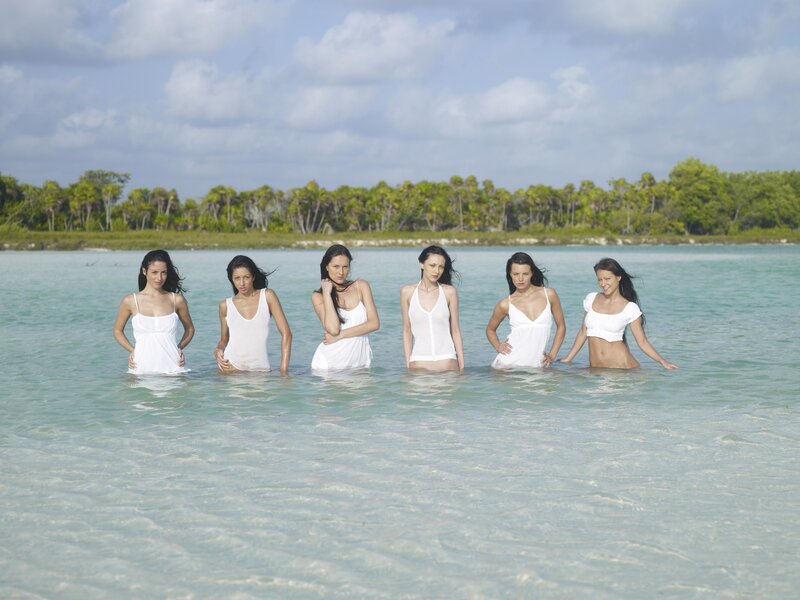 Women in white dresses at the beach