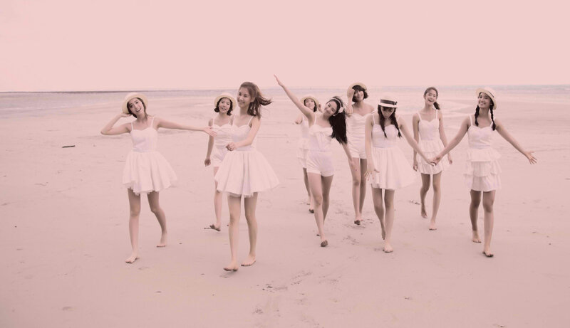women in white on beach