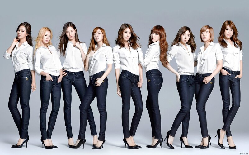 women in white shirts and jeans