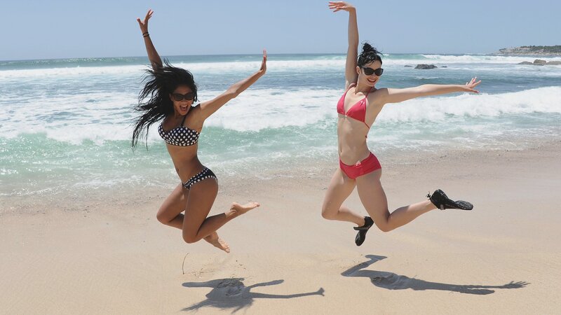 Women jumping on the beach