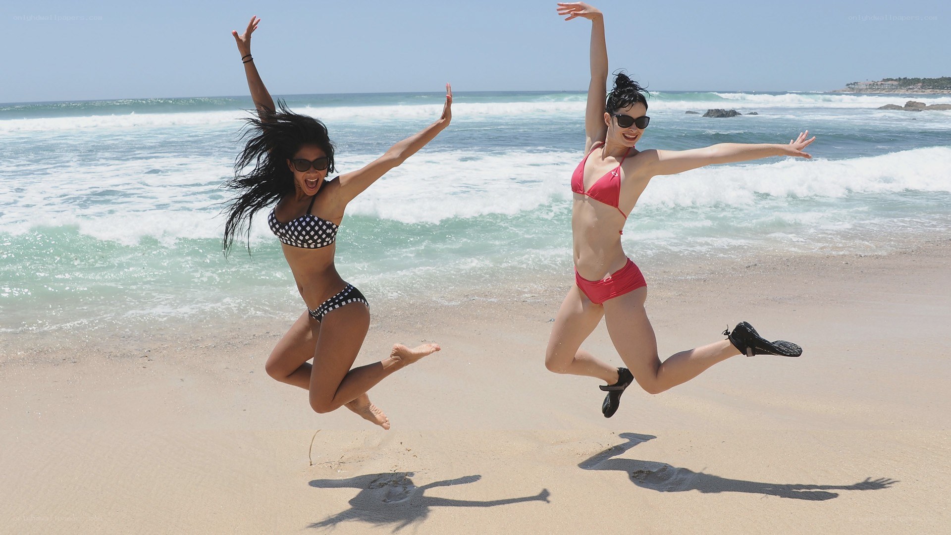 Women jumping on the beach
