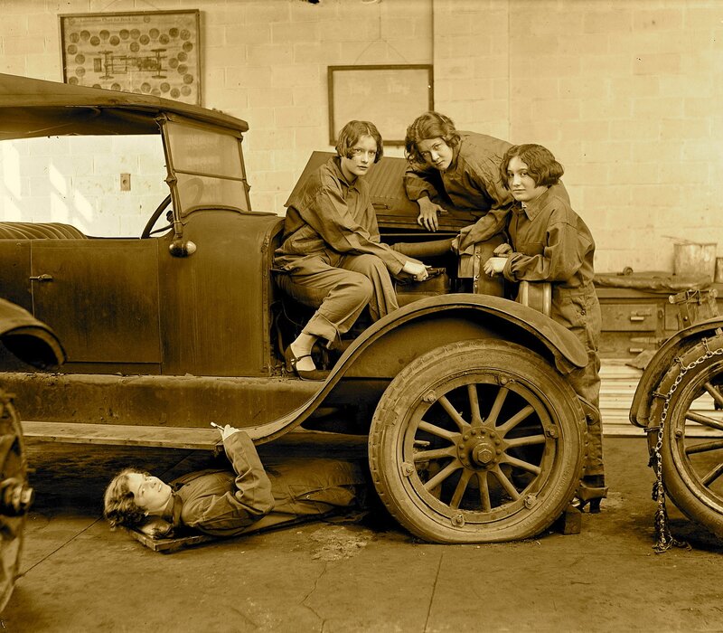 Women mechanics with vintage car