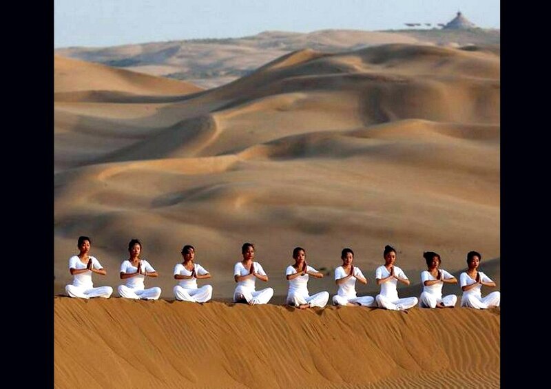 Women Meditating in Desert