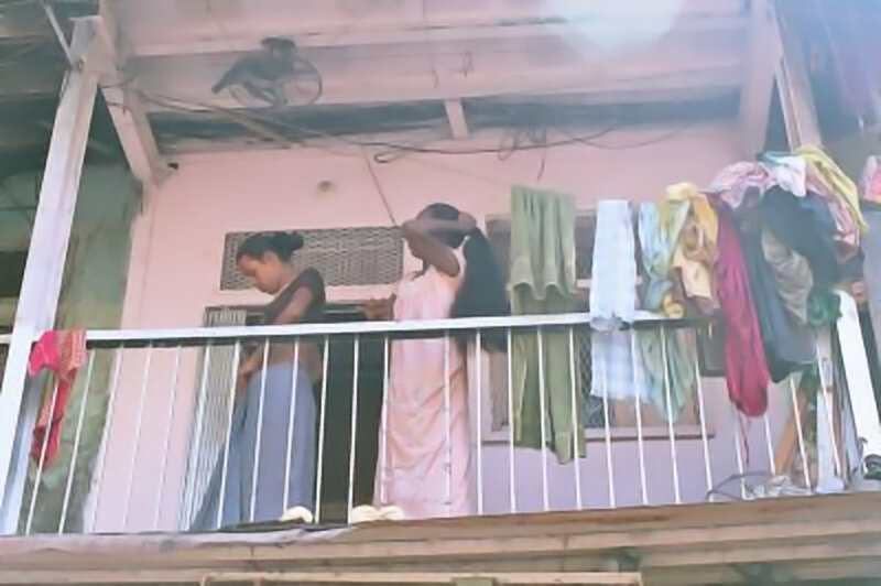 Women on a balcony with laundry
