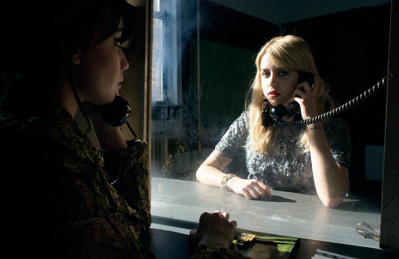 Women on phones in a booth