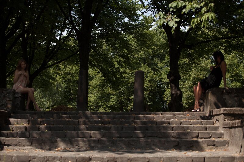 Women on stone steps in park
