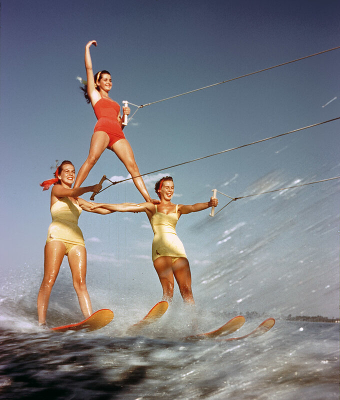 Women performing water ski stunt