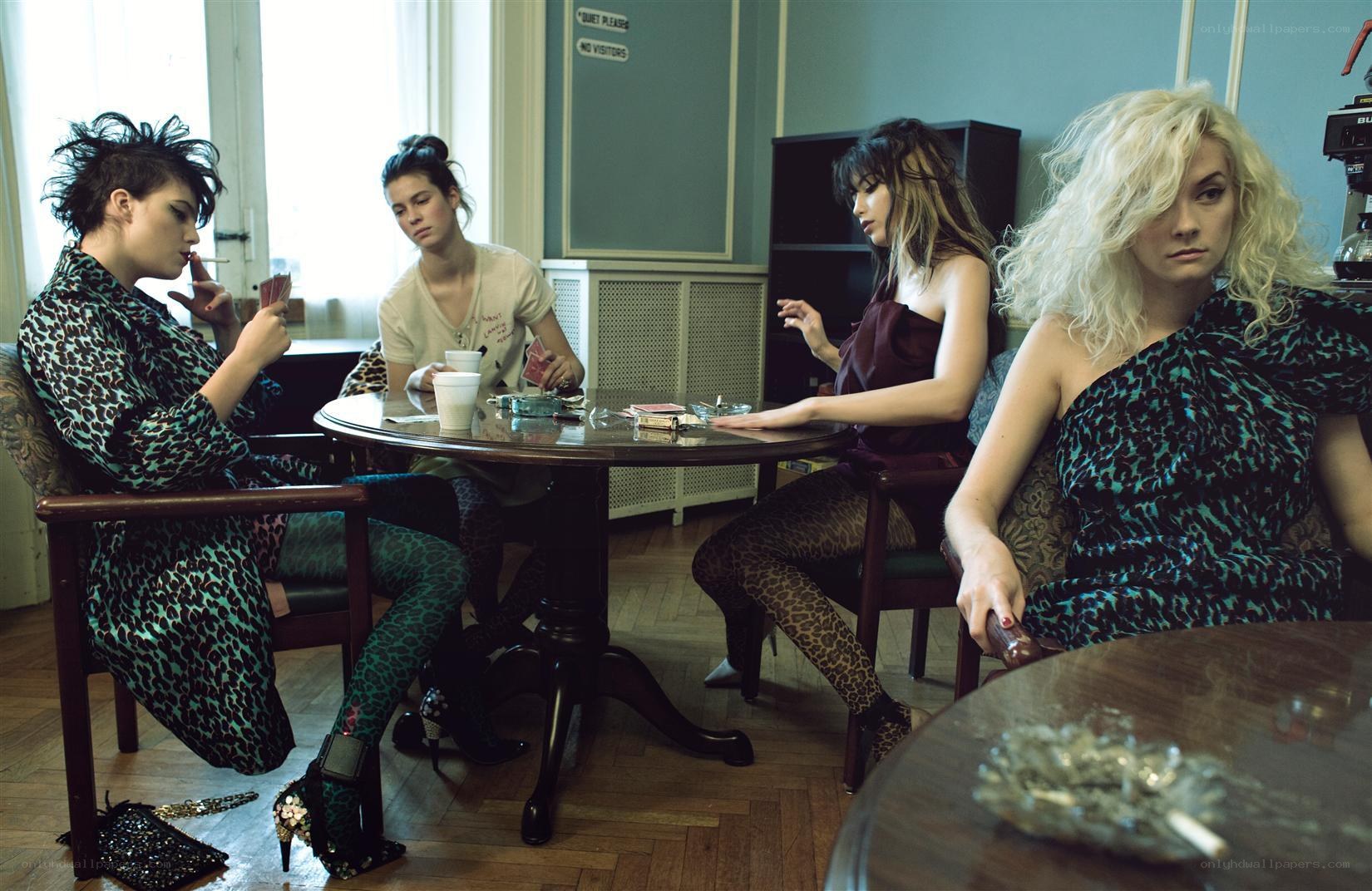 Women playing cards in a cafe