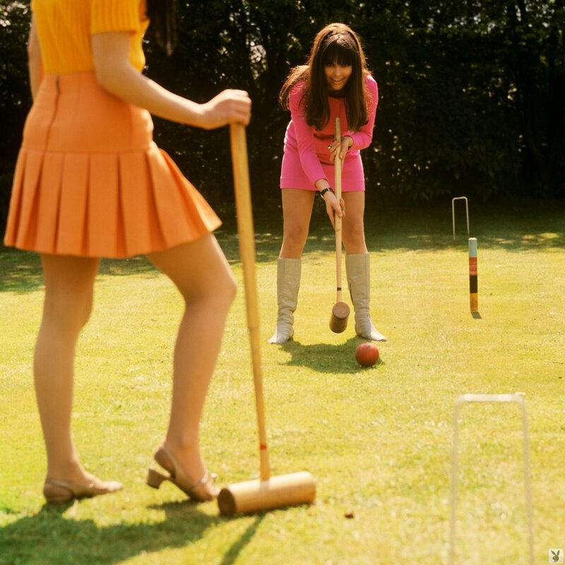 Women playing croquet in garden