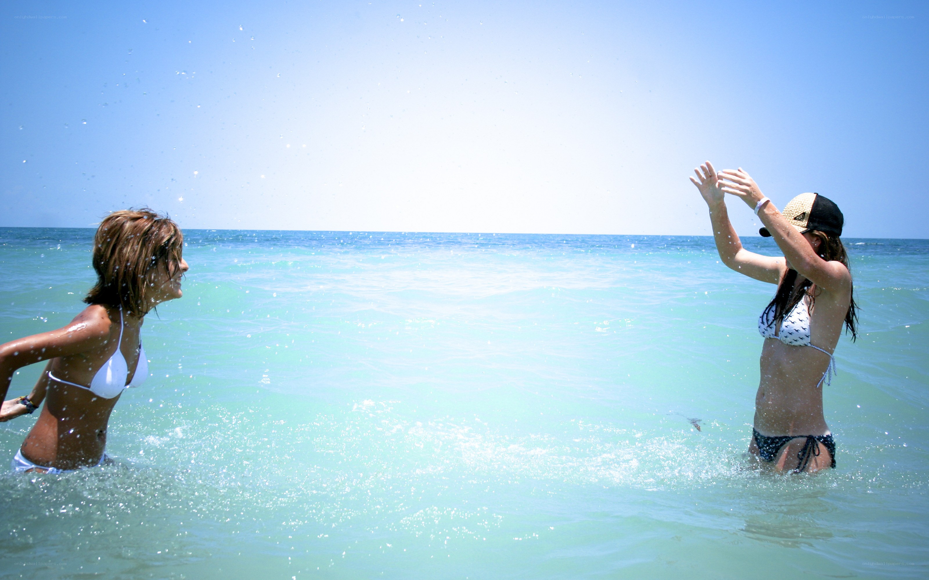 Women playing in ocean waves