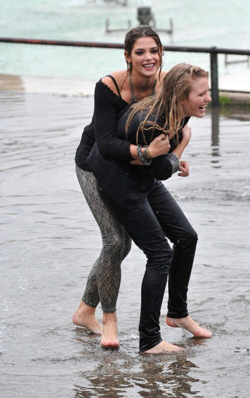 women playing in shallow water