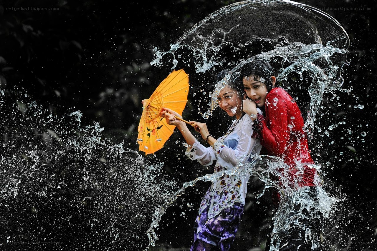 Women playing in water splashes