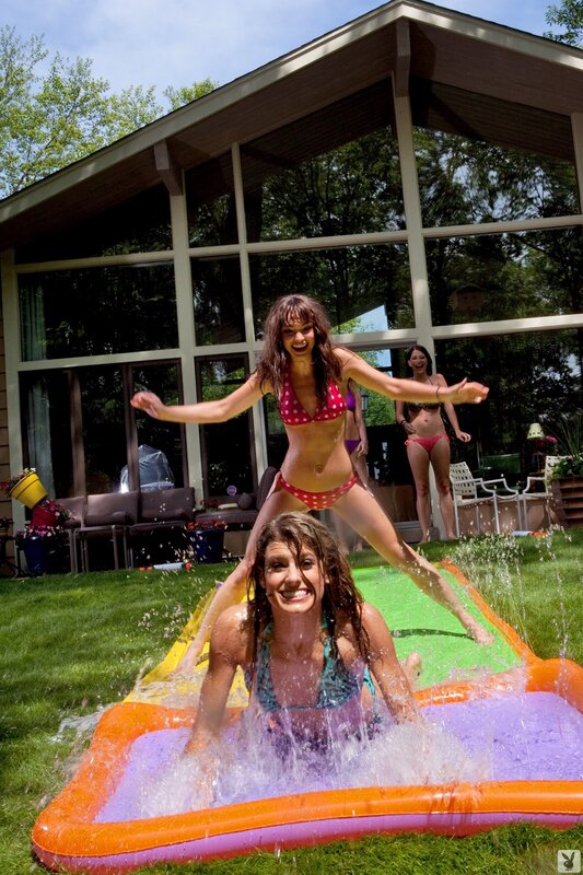 Women playing on water slide