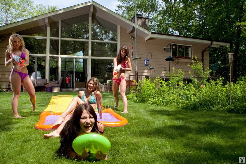 Women playing water games in backyard