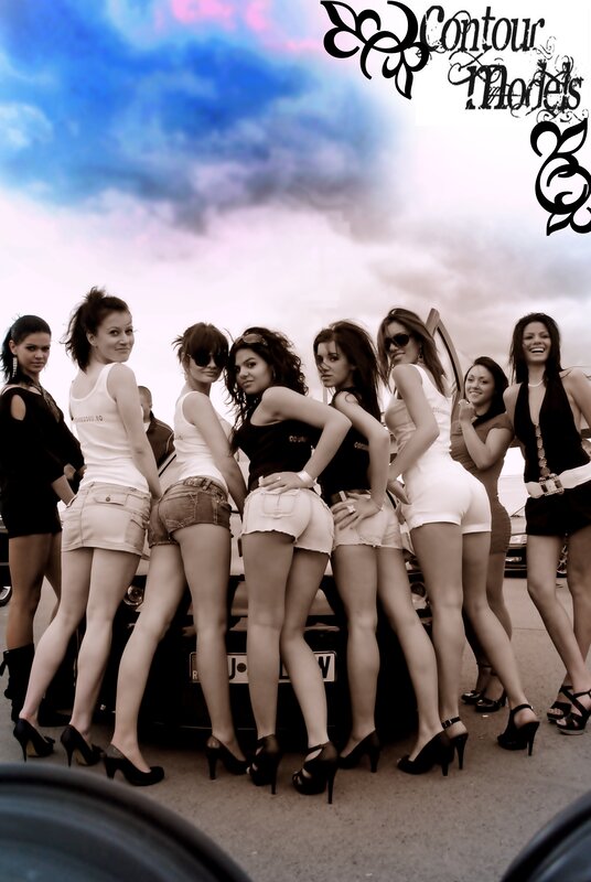Women posing at car event