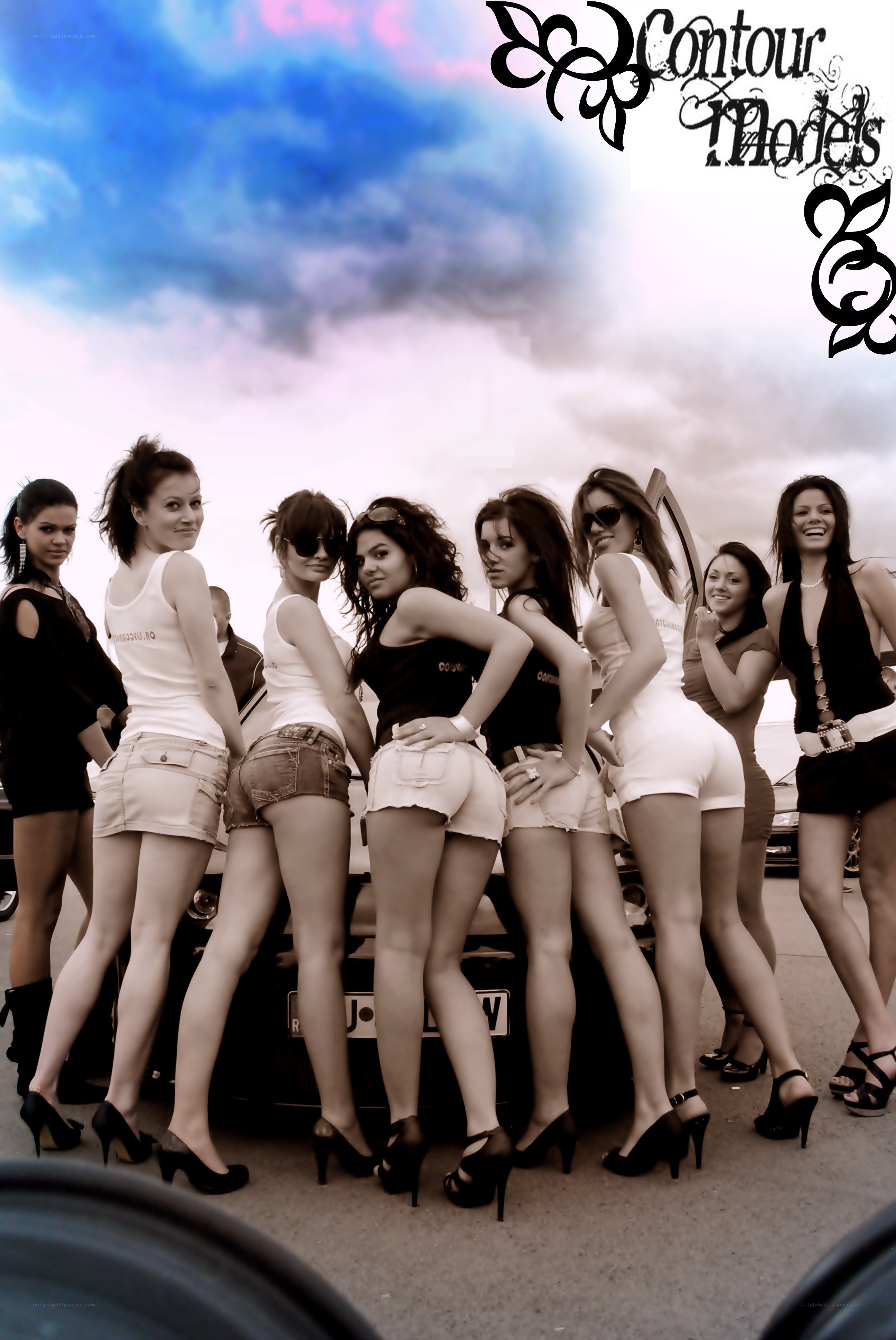 Women posing at car event