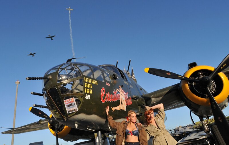 Women Posing by Bomber Plane