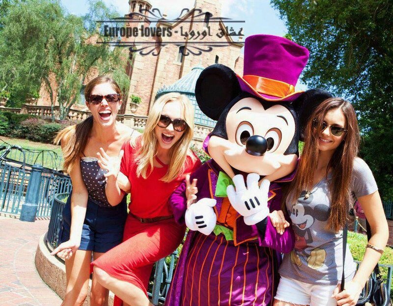 Women posing with Mickey Mouse