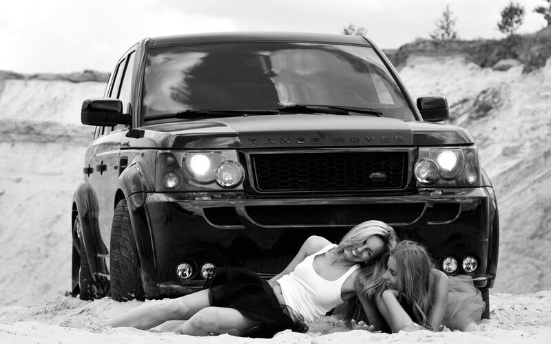 Women posing with Range Rover