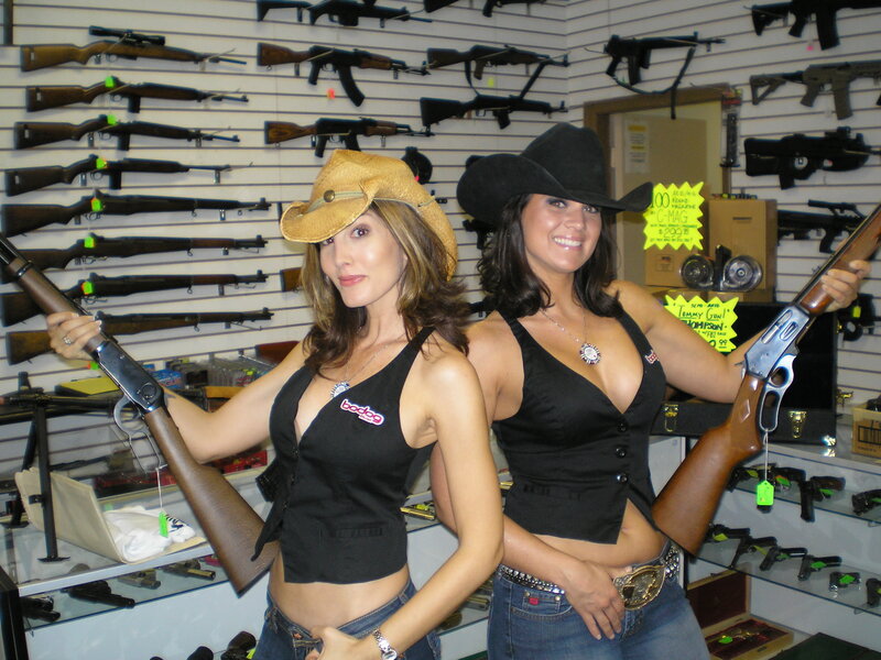 Women posing with rifles in gun store