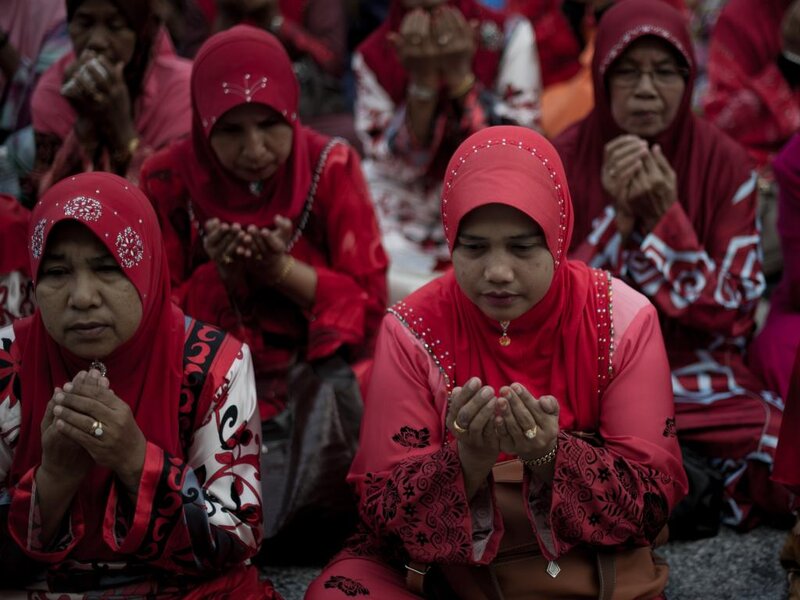Women Praying in Red