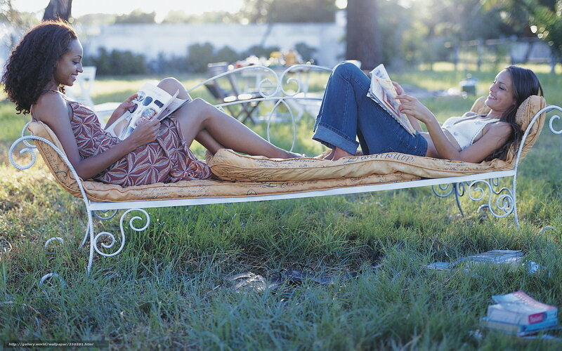 Women reading on a garden bench