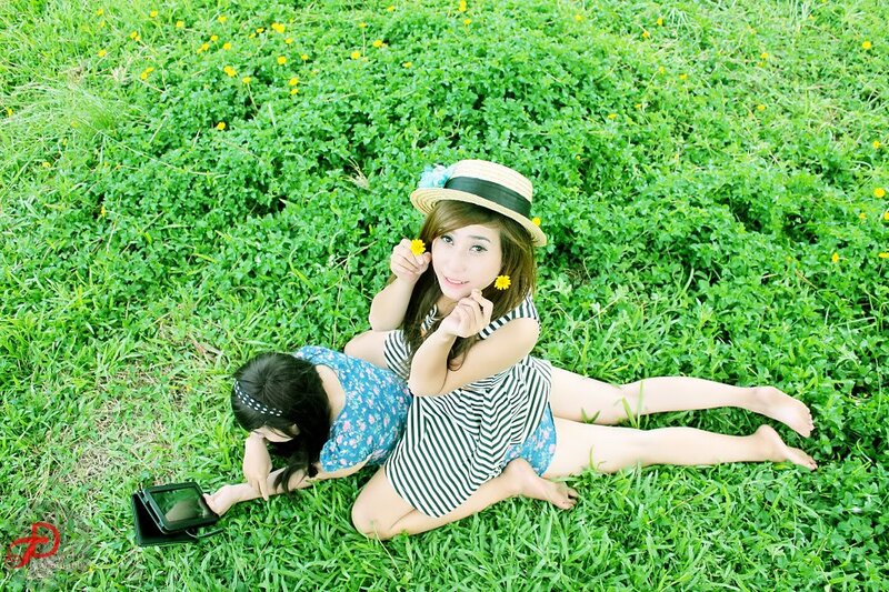 Women relaxing in a grassy field