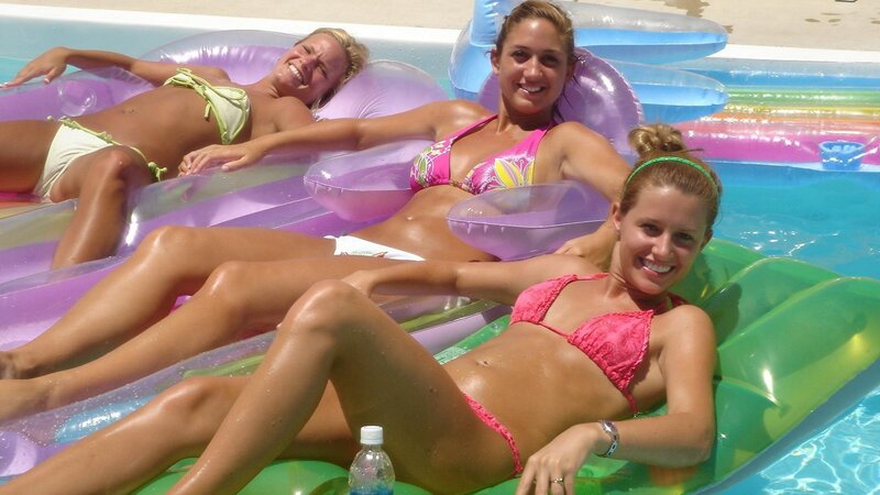Women relaxing on pool floats