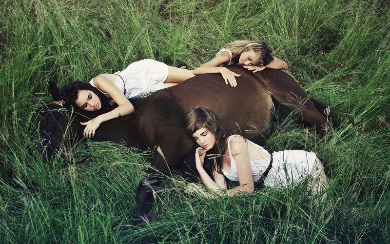 Women resting with a horse