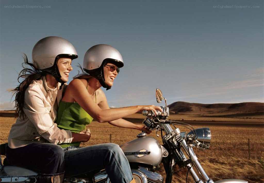 Women riding motorcycle together