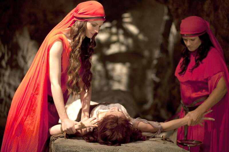 Women tending to a wounded person