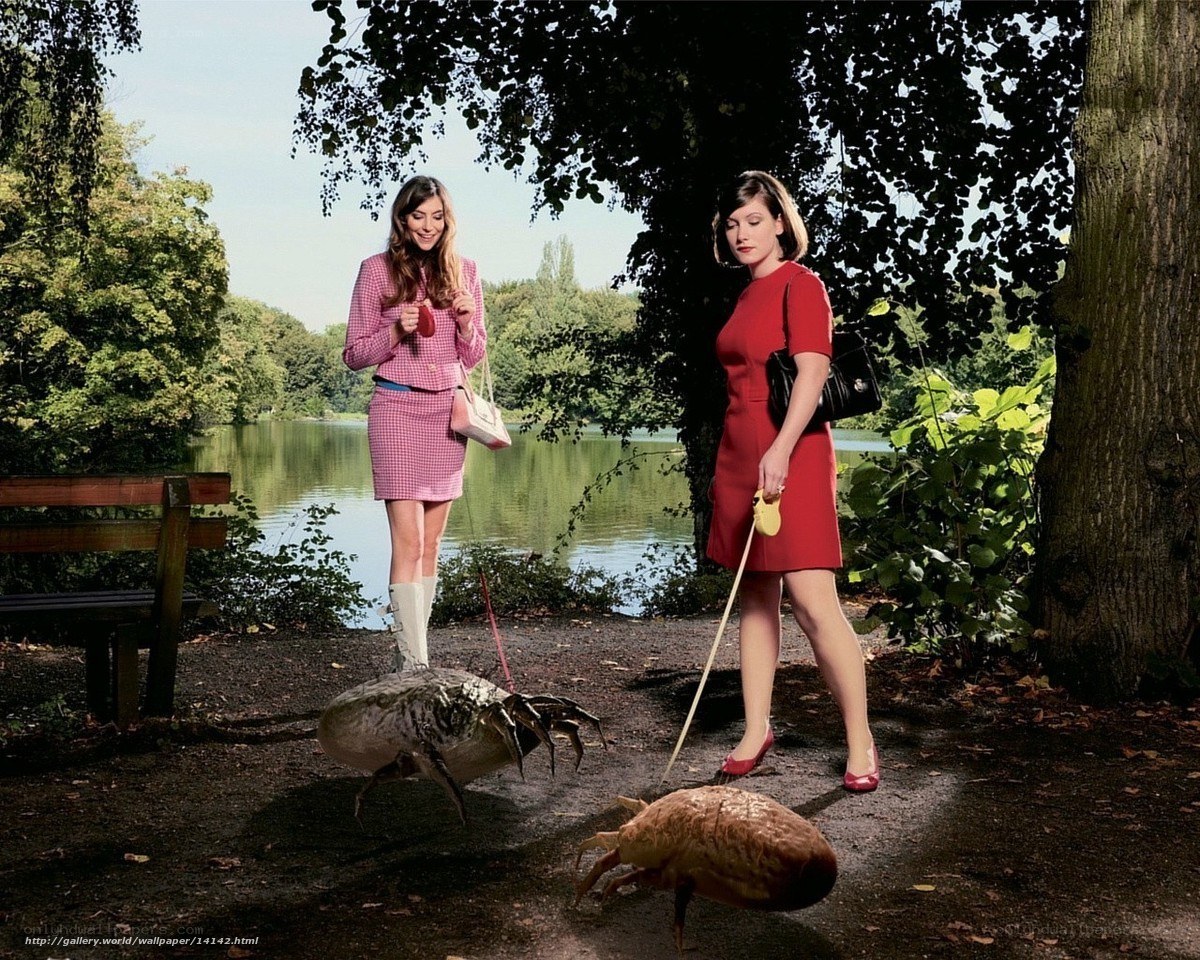 Women walking giant insects in park