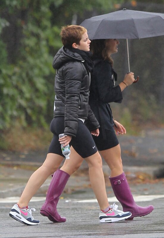 Women walking in rain with umbrella