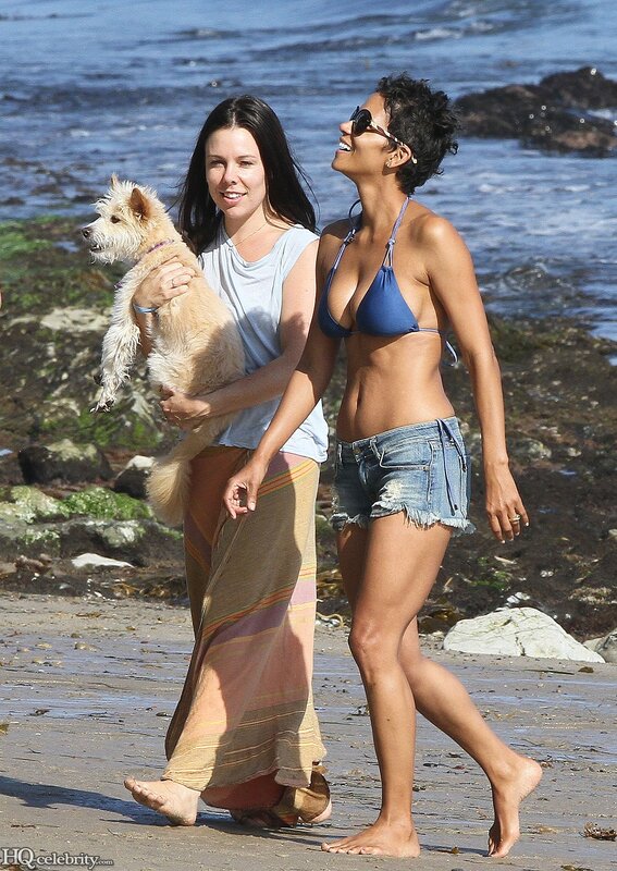 Women walking on beach with dog