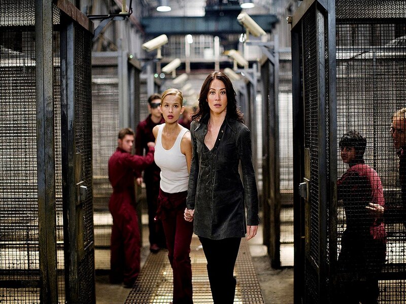 Women walking through prison corridor