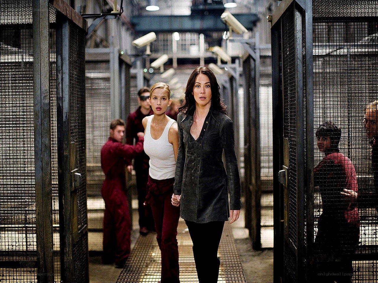 Women walking through prison corridor