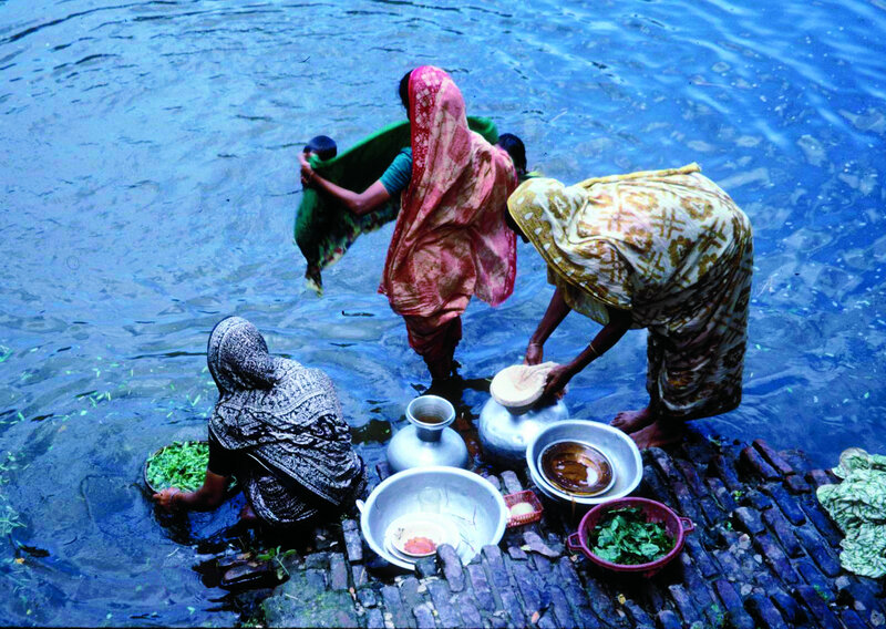 Women washing clothes by river