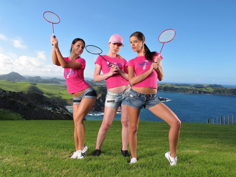 Women with badminton rackets on a hill