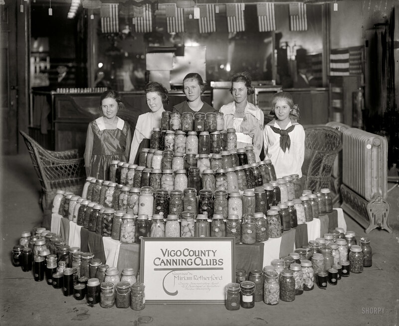 Women with canned goods display
