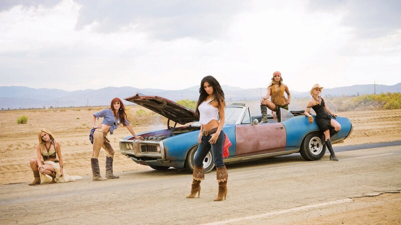 women with classic car in desert