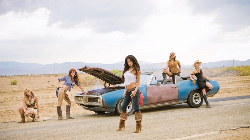 women with classic car in desert