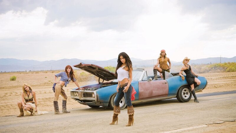 women with classic car in desert