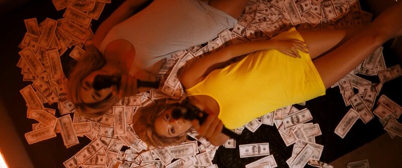 Women with guns in money