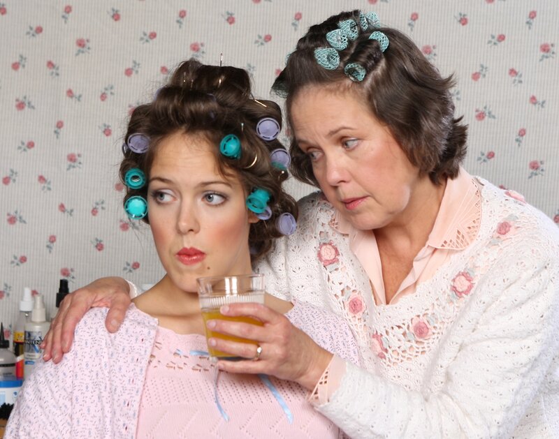 Women with hair rollers in vintage setting