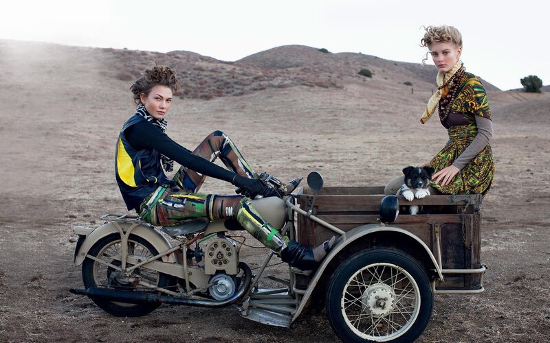 Women with motorcycle in desert