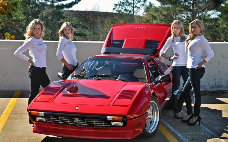 Women with red Ferrari car