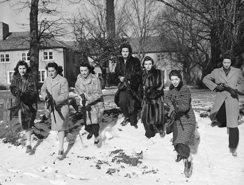 Women with rifles in snow