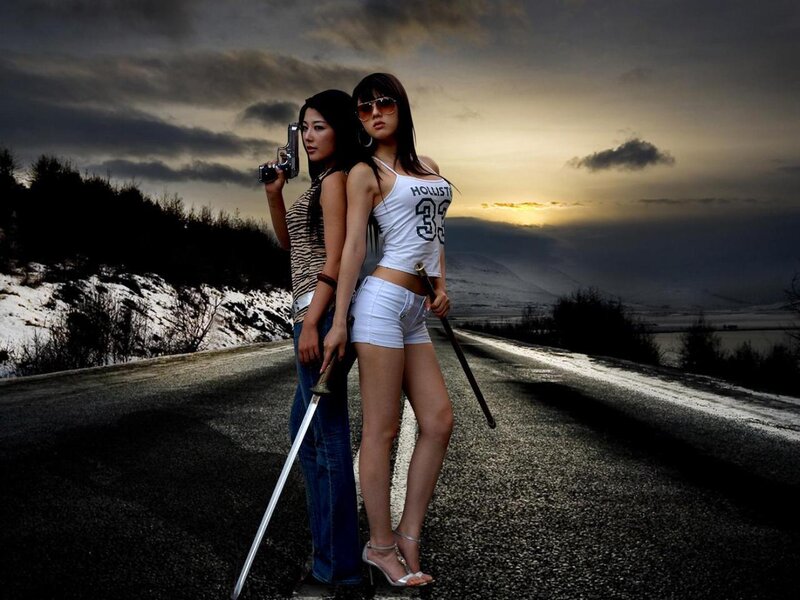 Women with weapons on a road