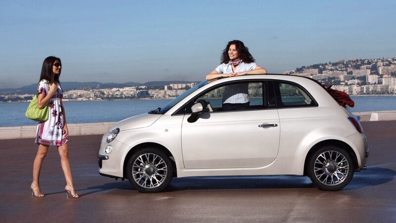 Women with white car by the sea